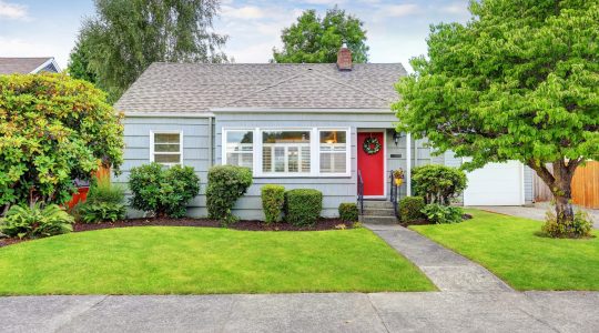 Exterior of small American house with blue paint; The Rise of Smaller Homes and Smaller Lots